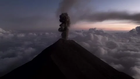 Aerial Volcano Eruption Ash Column Rising Above Clouds at Sunset Stock Footage 322182876