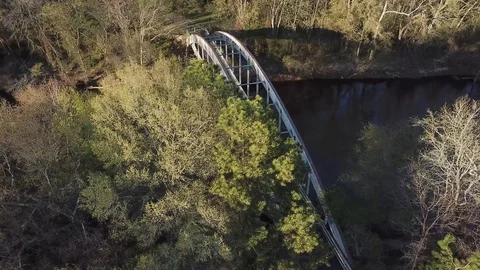 Aerial of Walking Bridge Spanning River Stock Footage 114891651