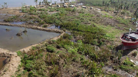 Aerial of washed up cargo ship in the midst of the devastated area Video stock 33830345