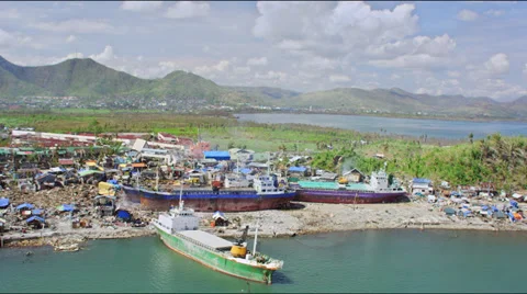 Aerial of washed up container ship in the midst of the devastated town Stock Footage 33773538