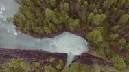 Aerial Of Water Flowing In Speed Through The Eroded Rocky Mountain Stock Footage
