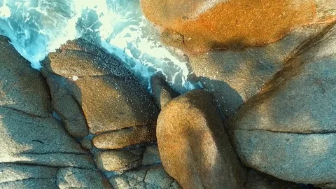 Aerial: Water splash on the rocks. Stock Footage 69868522