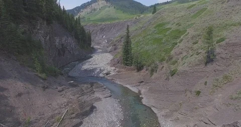 Aerial of water stream flowing through Canadian Rockies Stock Footage 69740104