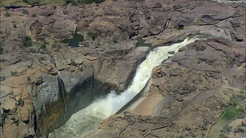 Aerial of waterfall falling down the cliff, Augrabies Falls Stock Footage 109445566