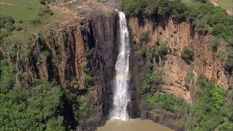 Aerial of waterfall falling down the hill into the river, People wash clothes Stock Footage 109441048