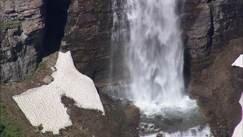 Aerial of waterfall flowing down the cliff, St MaryS Falls In Sun Stock Footage 109456086