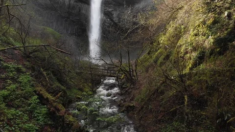 Aerial of waterfall with rushing river in between lush forest reveal shot Stock-Footage 107123704