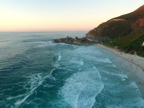 Aerial of Waves and Rocks and Sunset Beach in Cape Town Stock Footage 79769939