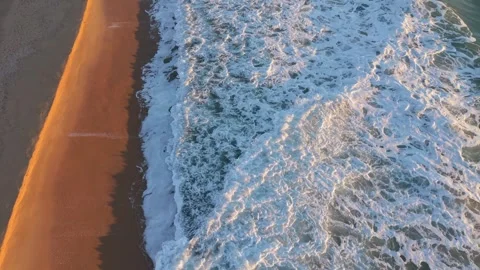 Aerial Waves Breaking Along Sandy Beach With Foam Texture Stock Footage 328142647