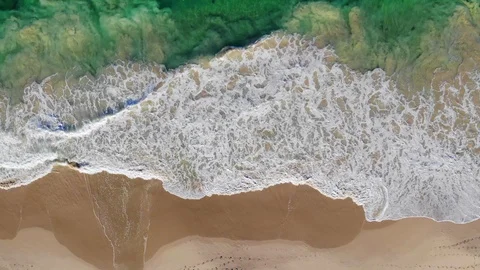 Aerial of Waves Breaking onto Beach Stock Footage 123760754
