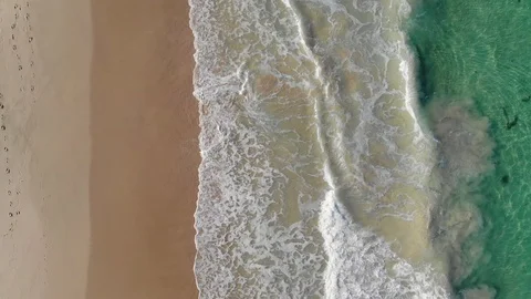 Aerial of Waves Breaking onto Beach Stock Footage 123815586