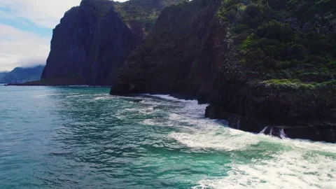 Aerial of waves breaking on a dramatic north cliffs of Madeira Portugal Video stock 329247896