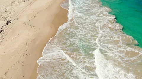 Aerial of Waves Breaking onto Sand Stock Footage 115958678
