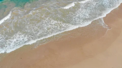 Aerial of Waves Breaking onto Sand Stock Footage 116147281
