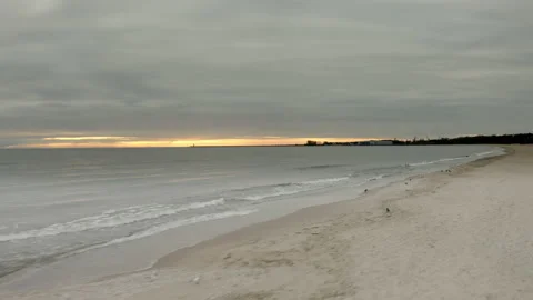 AERIAL: Waves Breaking on a Sandy Beach Stock Footage 131245293