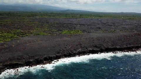 Aerial: Waves crashed against a massive lava field 库存影片 96184533