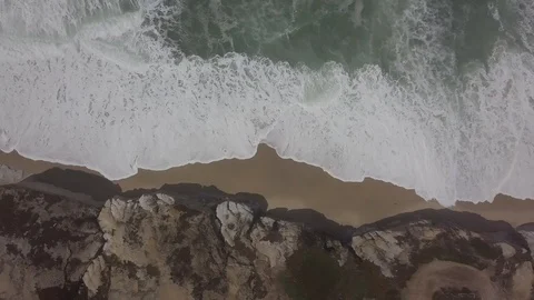 Aerial: Waves crushing on a sandy beach Portugal Stock Footage 92685873