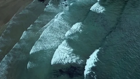Aerial of waves rolling into the beach. Atlantic Ocean. Birdview Shot Stock Footage 104636633