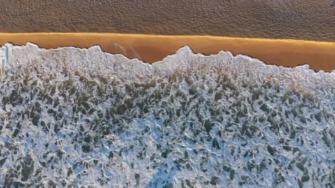 Aerial Waves Rolling Onto Sandy Beach Stock Footage 328142732