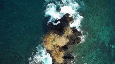 Aerial of waves splashing on the rock formation in the turquoise sea Stock-Footage 81449335