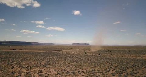 Aerial weather - orbiting a dust devil as it blows through Monument Valley Stock Footage 107115252