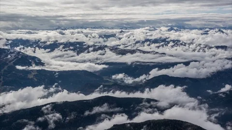 Aerial of white clouds floating over the mountain ranges Stock Footage 77814628
