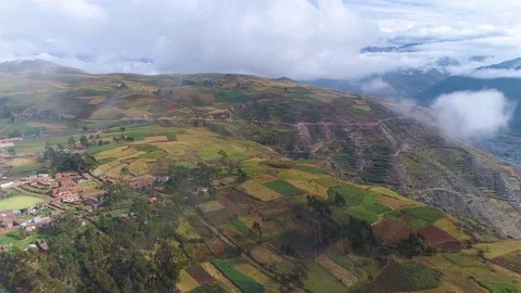 Aerial of white clouds floating over patchwork fields Stock Footage 79677655
