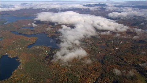 Aerial of white clouds floating over the forest near the sea coast, Lakes, Woods Stock Footage 109137594