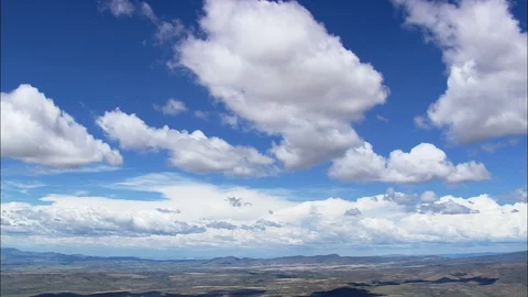 Aerial of white clouds moving over the landscape, Big blue sky with fluffy Stock Footage 109120992