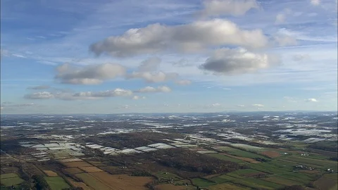 Aerial of white clouds over the fields, Fields covered in snow, blue sky Stock Footage 109138568
