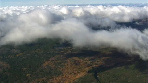 Aerial of white clouds over the green landscape, In the clouds over green Stock Footage 109136271