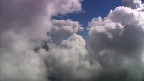Aerial of white puffy clouds in blue sky, In Amongst The Clouds Stock Footage 108590213