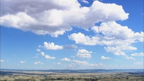 Aerial of white puffy clouds over green landscape, Little Bighorn Battlefield Stock Footage 109465308
