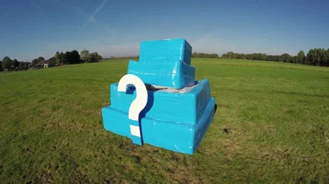 Aerial of white question mark on small blue structure drone flying to right 4k Stock Footage 68912160