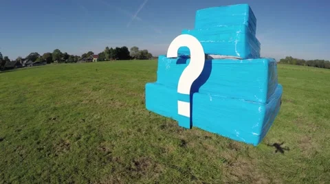 Aerial of white question mark on small bright blue structure 4k Stock Footage 68912348