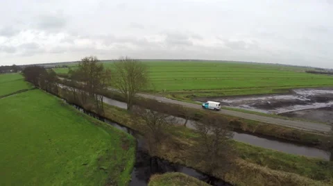 Aerial of white van moving behind trees driving rural road delivery truck 4k Stock Footage 59921414