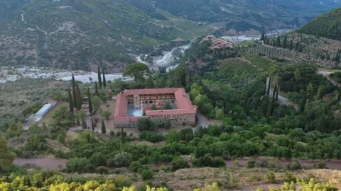 Aerial wide angle of Byzantine monastery castle and vineyards by river Stock Footage 343962490