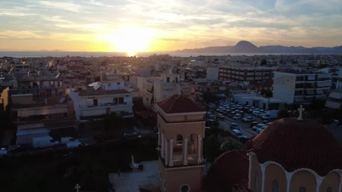 Aerial wide angle cityscape at sunset with church bell tower in Greece Stock Footage 343943848