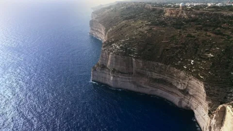 Aerial wide angle high drone shot slowly panning away from the dingli cliffs Stock Footage 336431850
