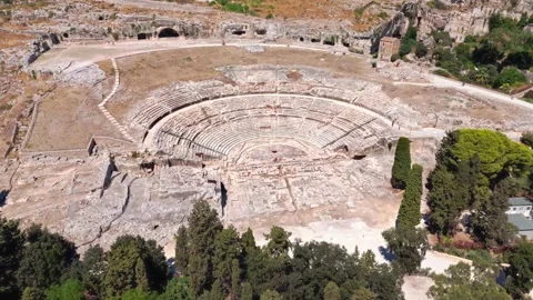 Aerial wide angle panning drone view of greek amphitheatre In Syracuse, Sicily Stock Footage 346879989