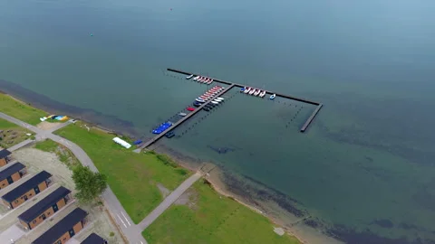 Aerial wide angle panoramic view of small sailboats and motorboats moored Stock Footage 339632869