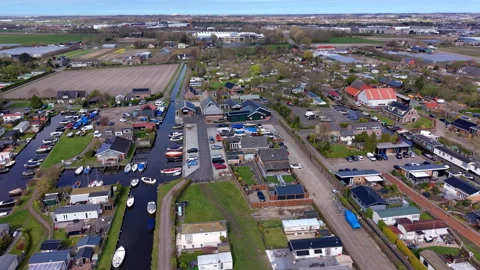 Aerial wide angle panoramic view of a cozy Dutch canal village with small Stock Footage 339632881