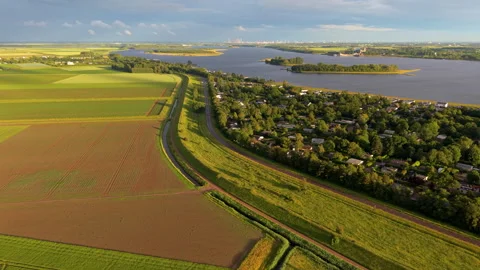 Aerial wide angle panoramic view of a massive green grassy dyke protection Stock Footage 339633489