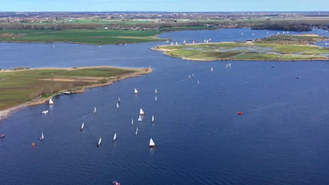 Aerial wide angle panoramic view of numerous white sailboats participating Stock Footage 339976807