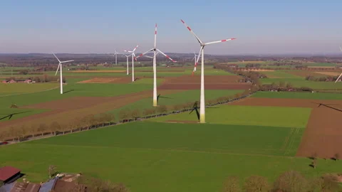 Aerial wide angle panoramic view of modern white wind turbines generating Video stock 339976880