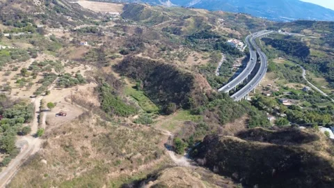 Aerial wide angle panoramic view of highway bridge entering tunnel Stock Footage 343962356