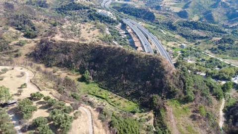 Aerial wide angle push-out shot of highway bridge in wild landscape Stock Footage 343960973