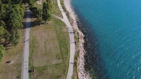 Aerial wide angle seaside park with walking path and ocean scenery Stock Footage 343946461