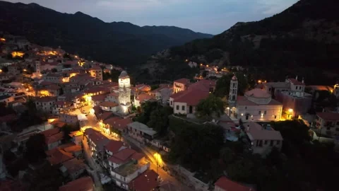 Aerial wide angle shot of bell tower above historic village at night Stock Footage 343944579