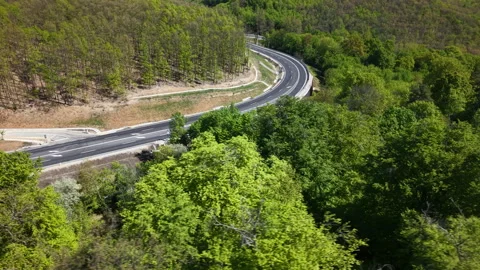 An aerial wide-angle shot captures a new motorway construction project winding 動画素材 334153657